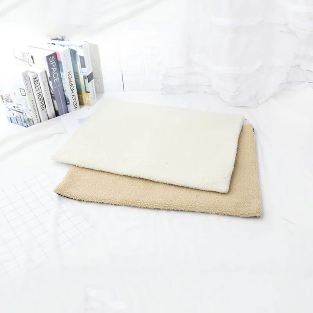 a bed with white sheets and a blanket